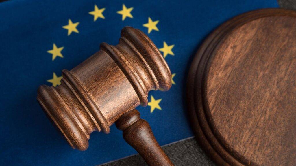 Wooden legal gavel with EU stars background representing EEA rights worker categories 2025 legal framework