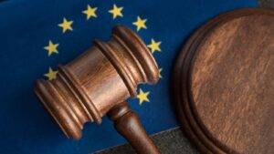 Wooden legal gavel with EU stars background representing EEA rights worker categories 2025 legal framework