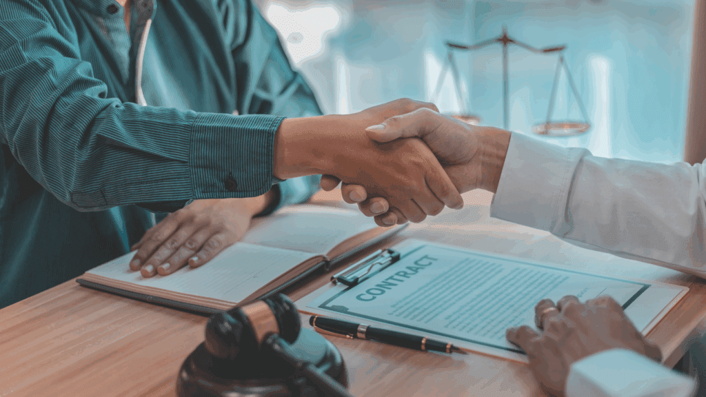 Professional handshake over legal contract documents with gavel representing successful EU Settlement Scheme case studies 2025 outcomes