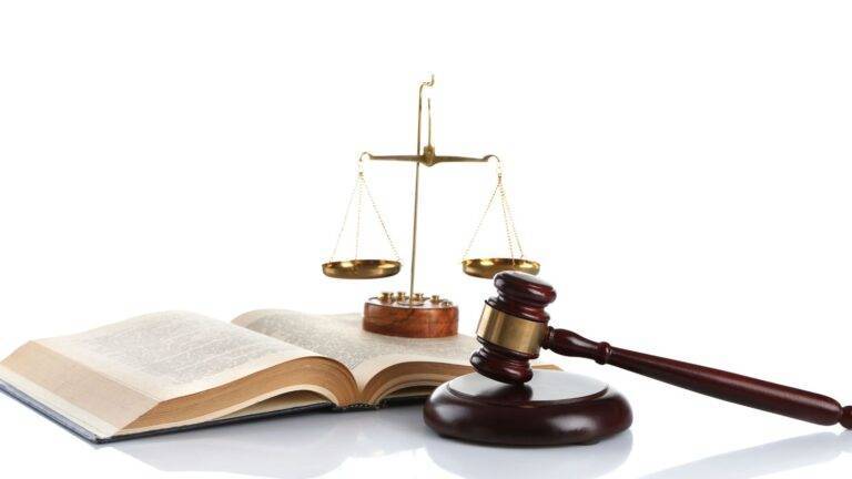 Legal Guidance For English Language Test Exemptions Uk 2026 Showing Scales Of Justice And Law Books Representing Immigration Legal Requirements