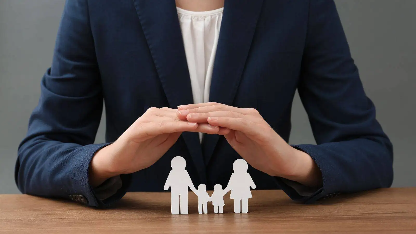 Professional hands protecting family figures representing non-molestation and occupation orders UK 2025 legal protection from domestic violence