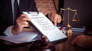 Professional legal desk scene with contract scales of justice gavel and property models representing caveat emptor property auctions UK 2025 legal framework
