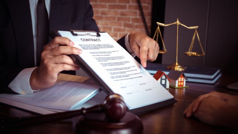 Professional legal desk scene with contract scales of justice gavel and property models representing caveat emptor property auctions UK 2025 legal framework