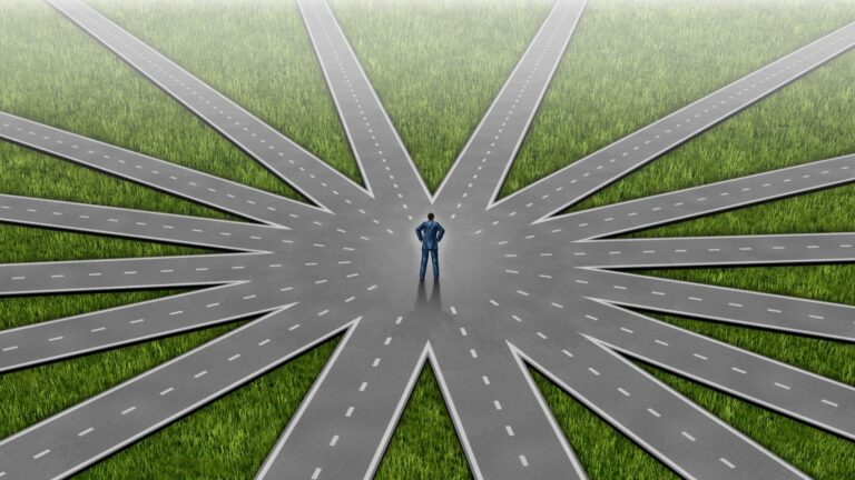 Aerial view of person at center of multiple radiating roads representing switching visa categories to skilled worker visa uk 2025 pathway decisions and route choices