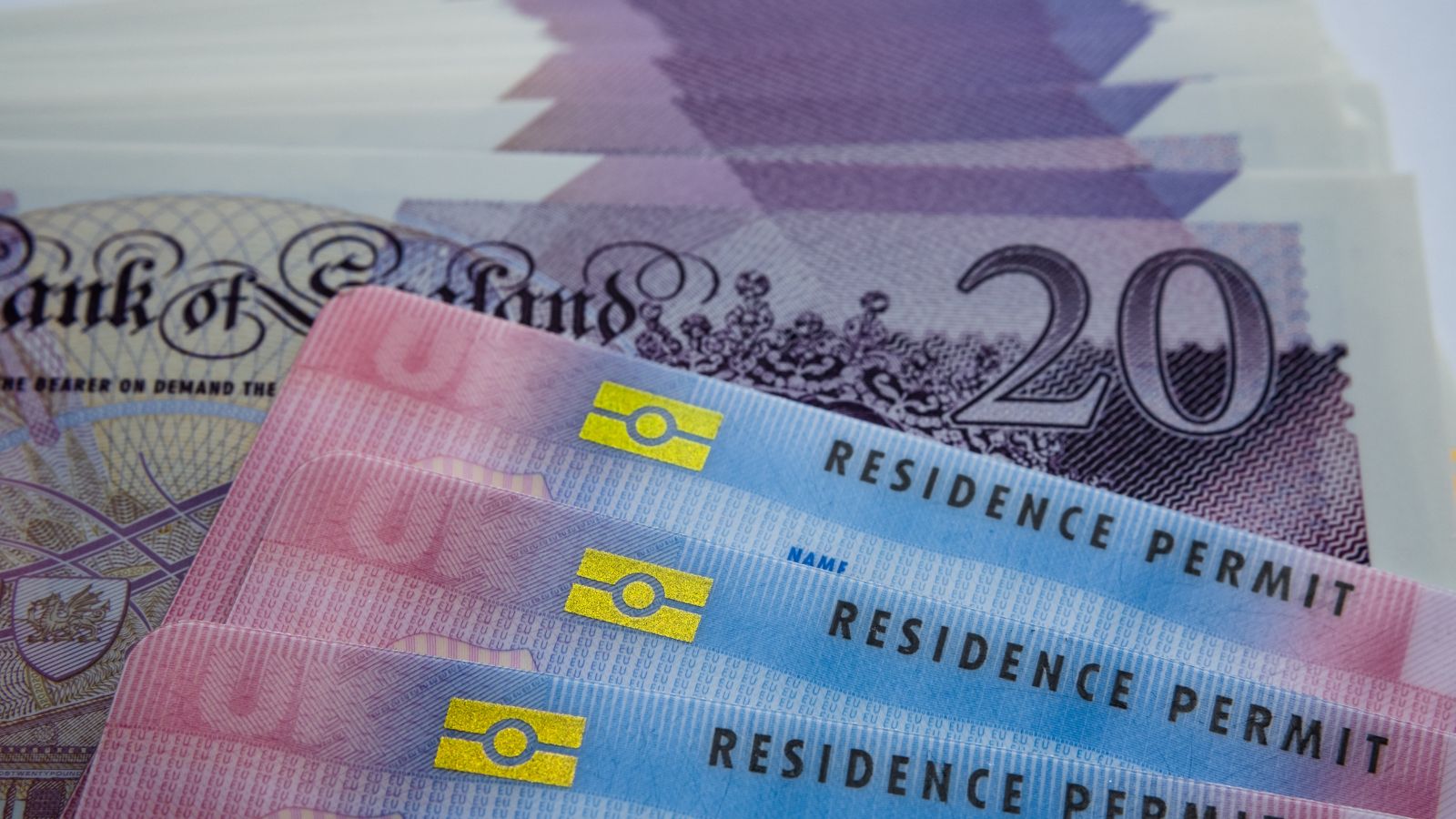 UK Biometric Residence Permit cards representing UK settlement routes 2025 and indefinite leave to remain status