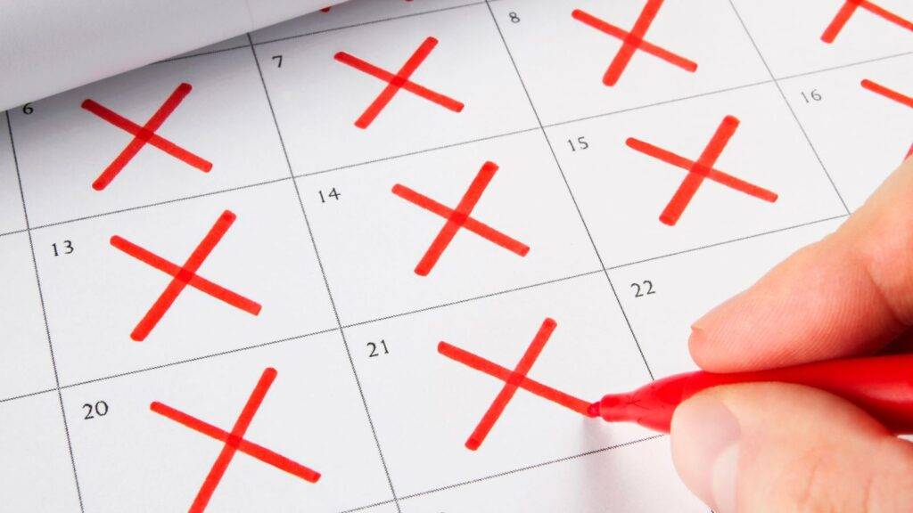 Calendar with red X marks showing 180 days absence rule ILR applications UK 2025 tracking requirements