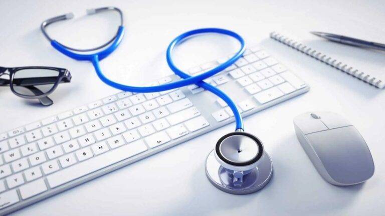 Medical stethoscope on professional desk with computer representing PLAB test UK visa requirements 2026 for international medical graduates