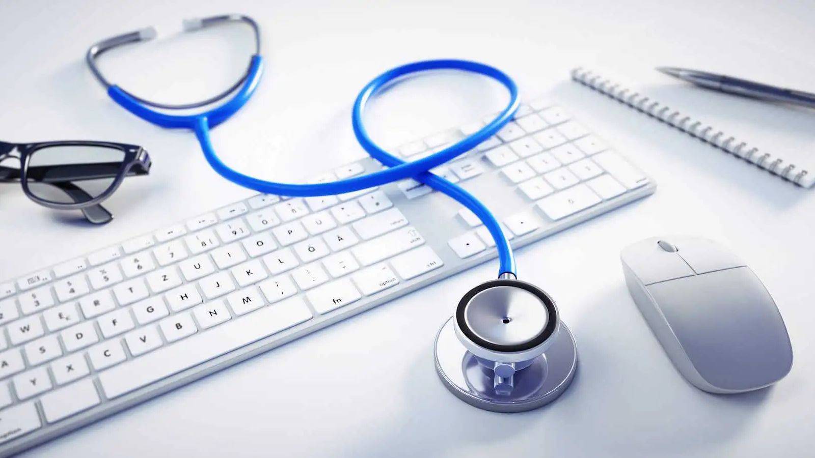 Medical stethoscope on professional desk with computer representing PLAB test UK visa requirements 2025 for international medical graduates