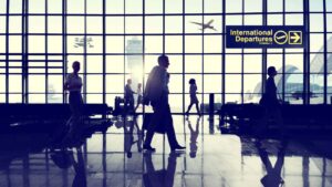 Airport International Departures Terminal With Travelers Representing Uk Citizenship Absence Rules 2025 Including 90-Day Final Year Limits And 450-Day Qualifying Period Requirements For Naturalization Applications