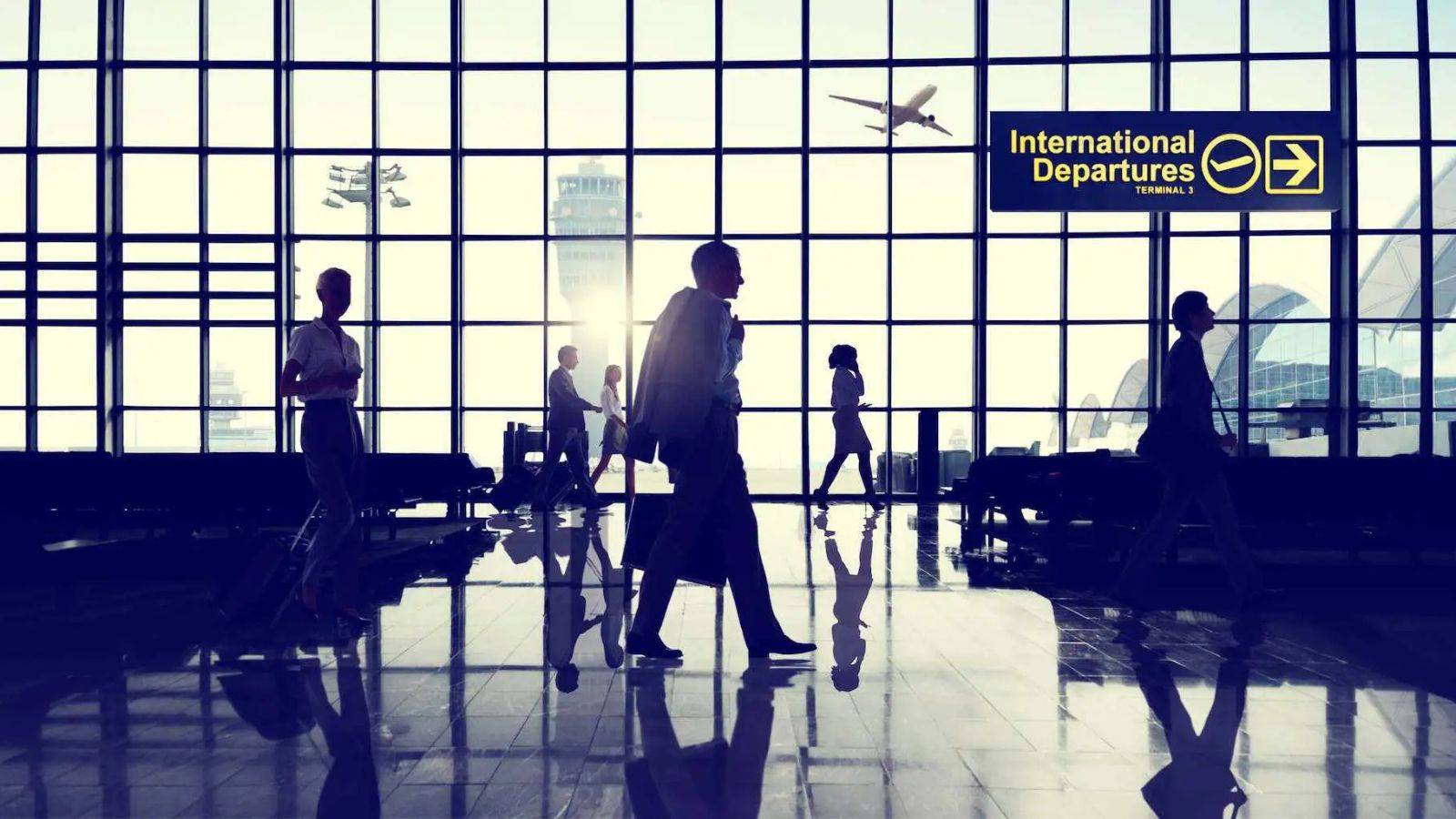 Airport international departures terminal with travelers representing uk citizenship absence rules 2025 including 90-day final year limits and 450-day qualifying period requirements for naturalization applications