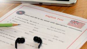 English Test paper with Union Jack flag and headphones representing english language requirements UK visa 2025 SELT assessment
