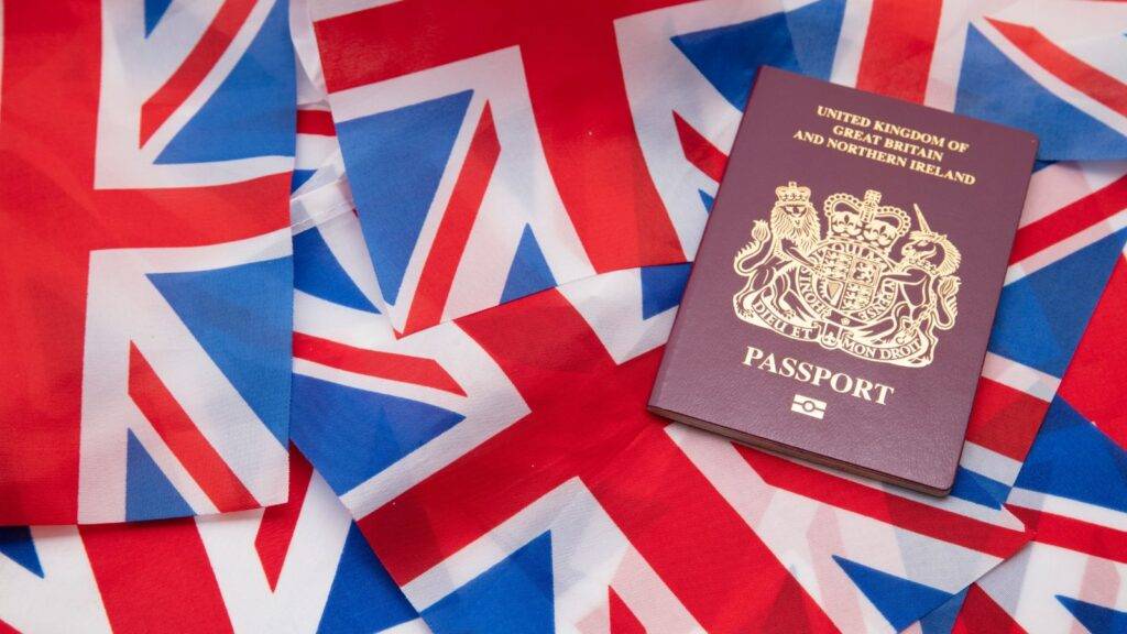 British passport on Union Jack flags representing is your child a british citizen documentation and citizenship status determination