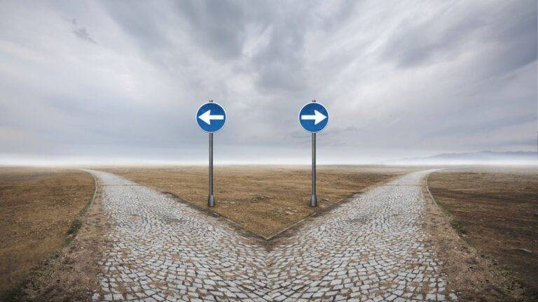 Directional arrow signs representing 5 year vs 10 year route UK 2025 immigration pathway choices