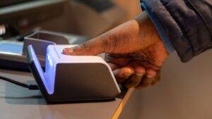 Hand using biometric fingerprint scanner for TOC application form 2025 biometric enrollment process