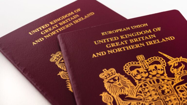 UK passports with royal coat of arms representing break in continuous residence UK 2025 legal requirements