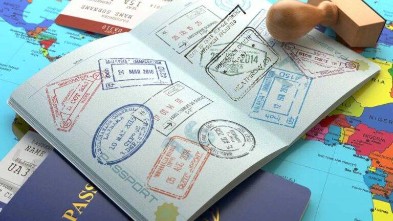 Open passport showing Heathrow Airport UK entry stamp with multiple international visa stamps representing ILR breaks in lawful leave UK 2026 continuous residence tracking requirements