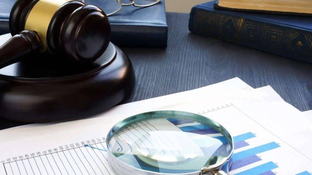 Judicial gavel with magnifying glass examining financial charts representing POCA confiscation order solicitors UK 2025 financial investigations and asset recovery proceedings