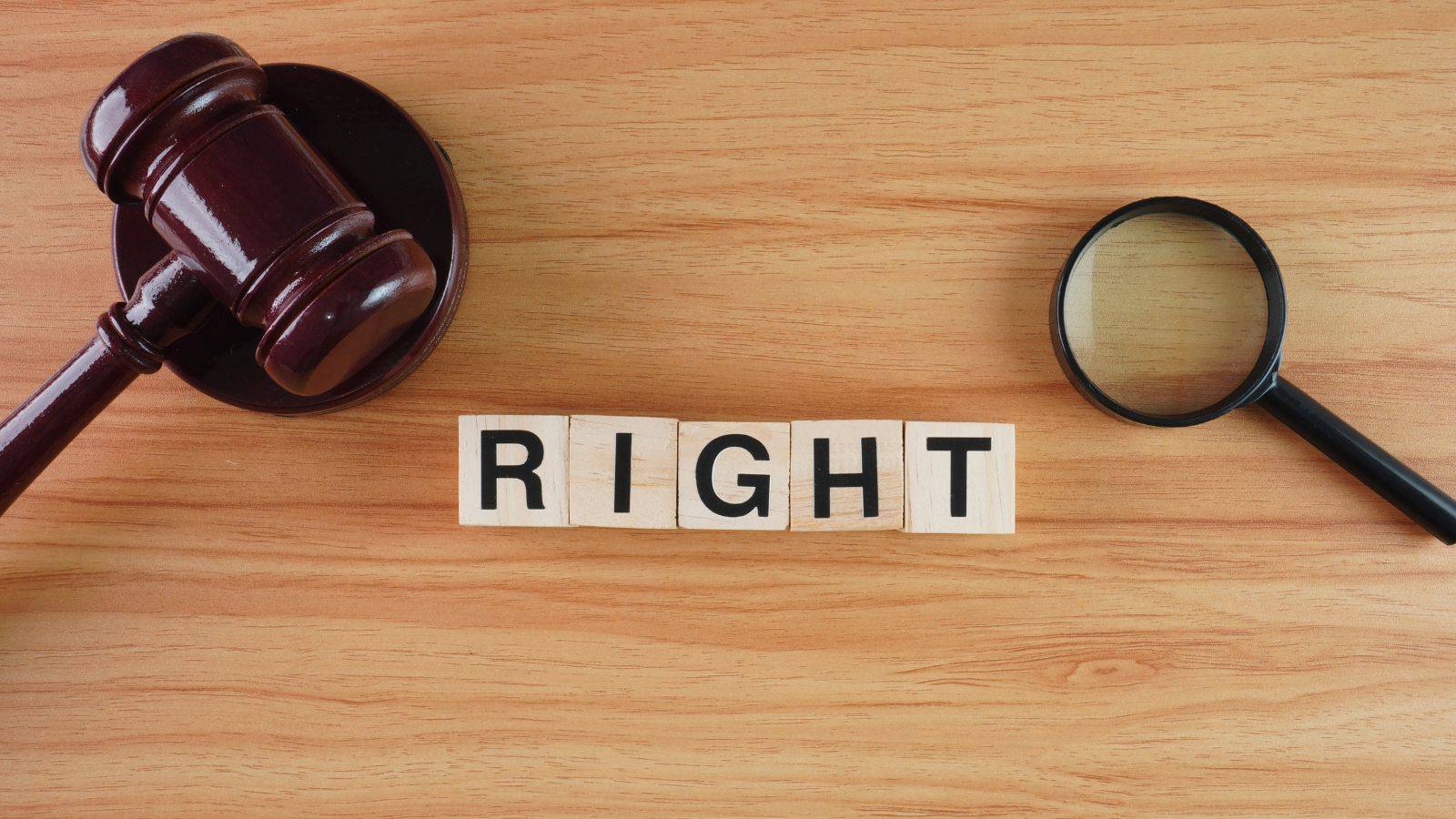 Legal gavel with RIGHT letter blocks and magnifying glass representing non-molestation orders UK 2025 legal rights and protections