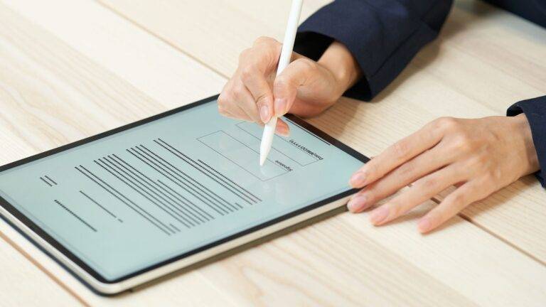 Professional Signing Digital Property Document On Tablet With Stylus - Hm Land Registry Digital Transformation 2025 Guide Showing Qes Qualified Electronic Signature Requirements For Paperless Conveyancing