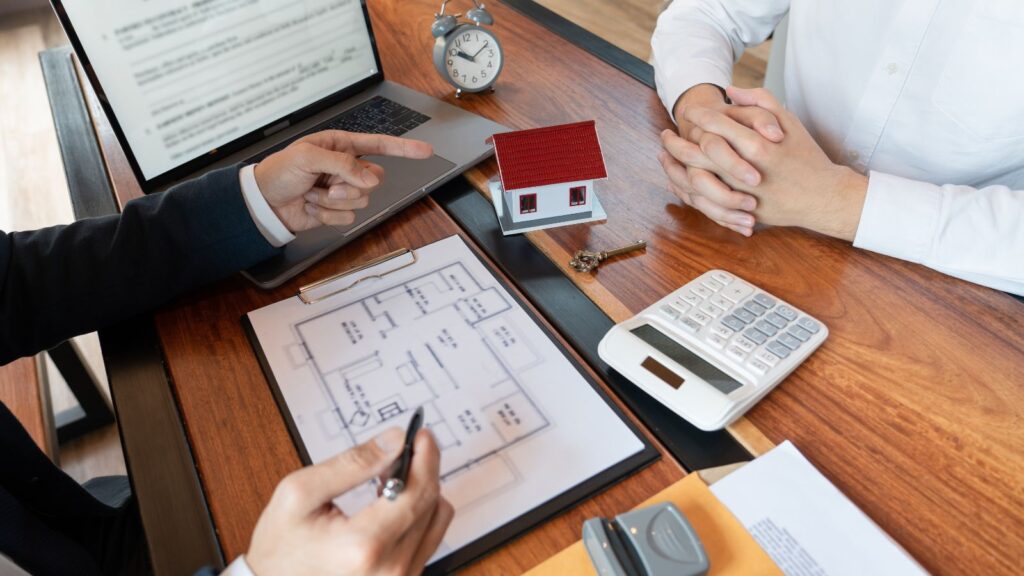 Professional property consultation with floor plans and house model representing statutory vs non statutory lease extension UK 2025 landlord strategic advice