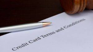 Credit card terms and conditions document with gavel and pen representing consumer credit act solicitors UK 2025 agreement review services
