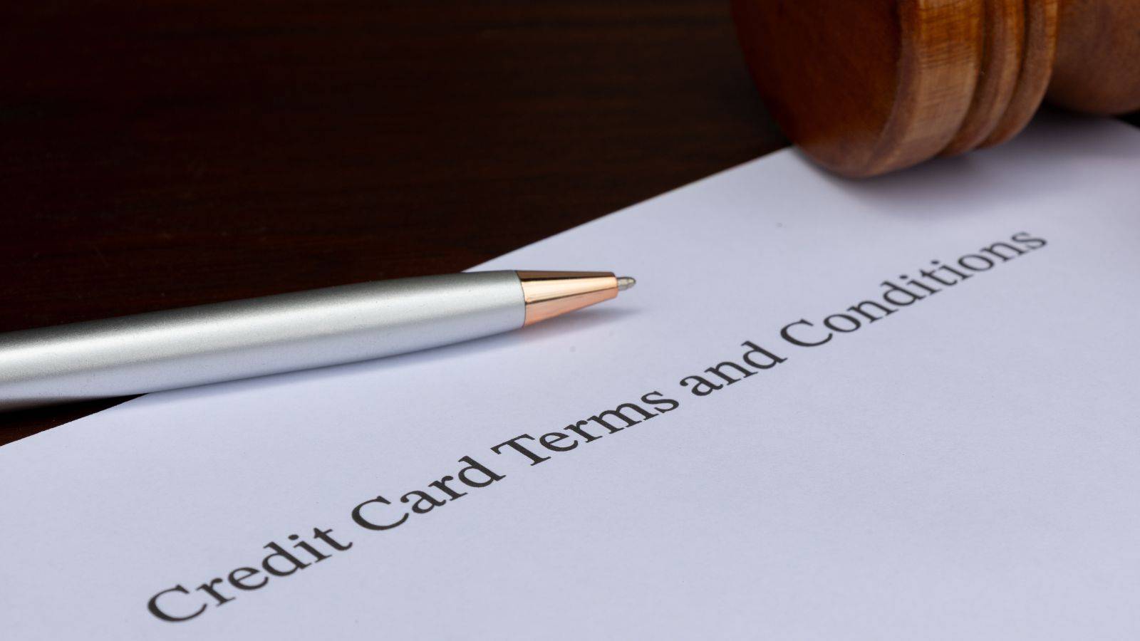 Credit card terms and conditions document with gavel and pen representing consumer credit act solicitors UK 2025 agreement review services