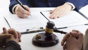 Divorce legal consultation with gavel and wedding rings on base representing decree nisi vs decree absolute UK court proceedings and documentation