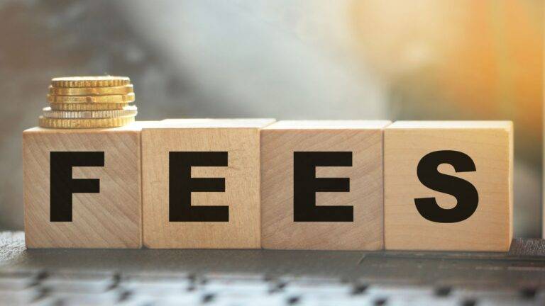 UK child citizenship fees 2025 represented by wooden blocks spelling FEES with British coins showing citizenship application costs fee waivers and legal challenges