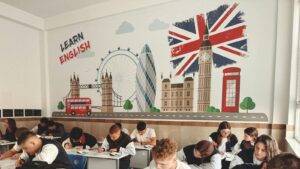 Children Learning English In Uk Classroom With British Landmarks Representing Child Student Visa Uk Educational Opportunities