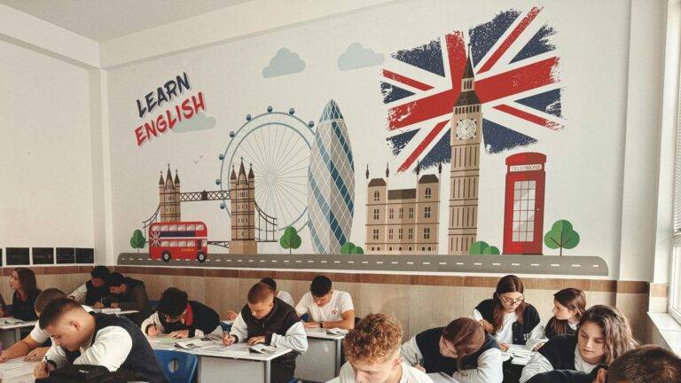 Children learning English in UK classroom with British landmarks representing child student visa UK educational opportunities