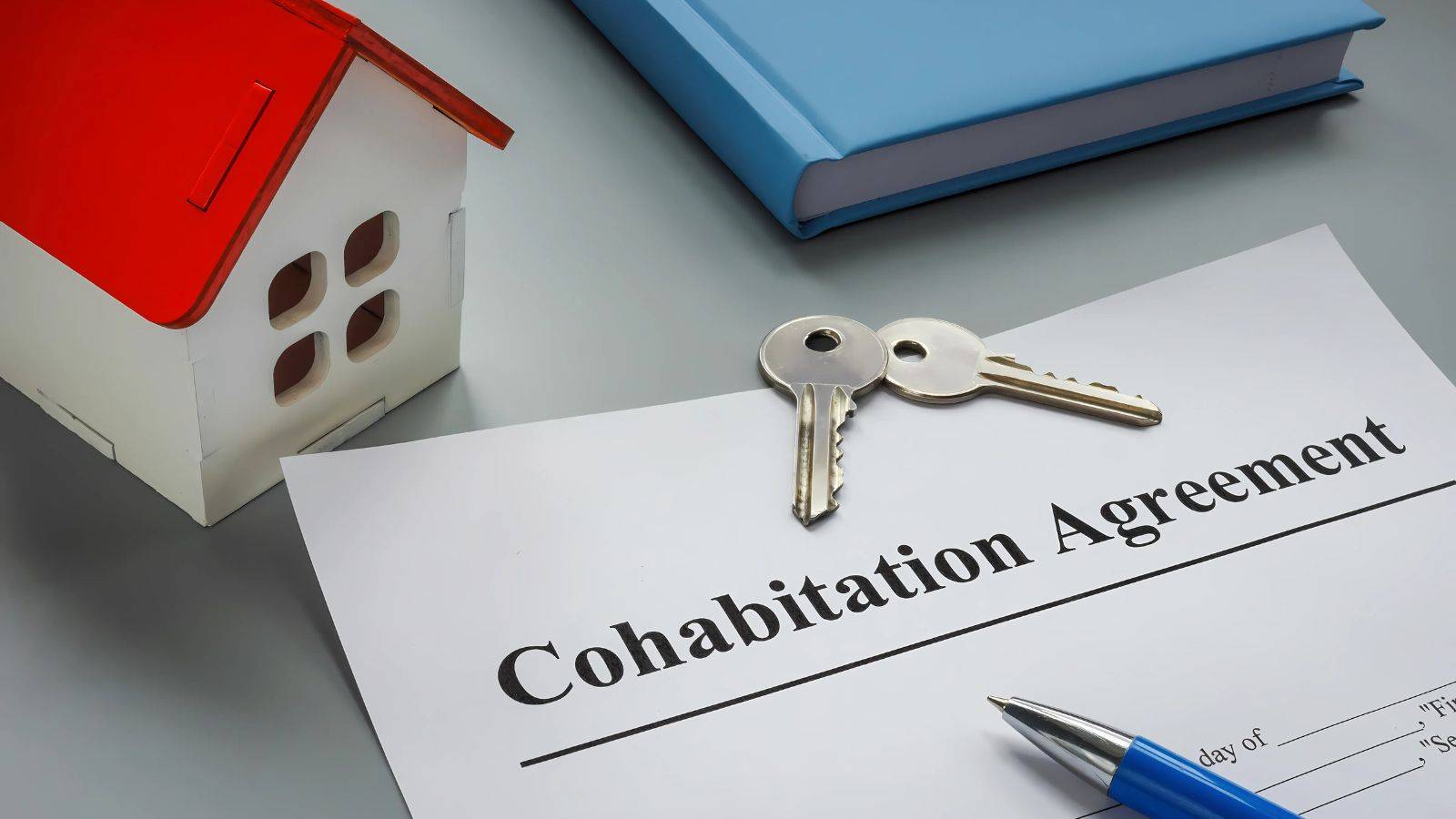 Cohabitation agreement with house model and keys representing unmarried couples rights on separation UK 2025 property disputes and legal protection