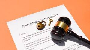 Eviction notice document with legal gavel and keys representing enforcement of possession orders UK procedures