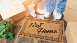 First Home Doormat With Moving Boxes Representing Buying First Home Uk Process For First-Time Buyers