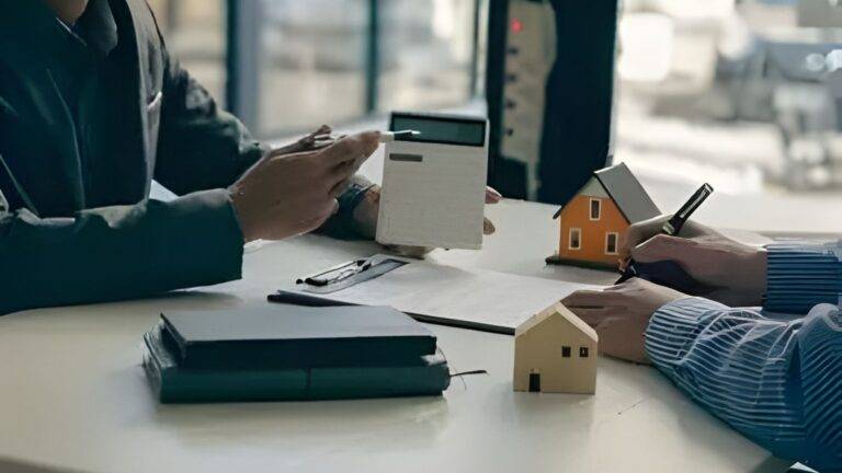 Property Professionals Discussing Home Mover Conveyancing Uk 2026 With Model Houses Calculator And Legal Documents