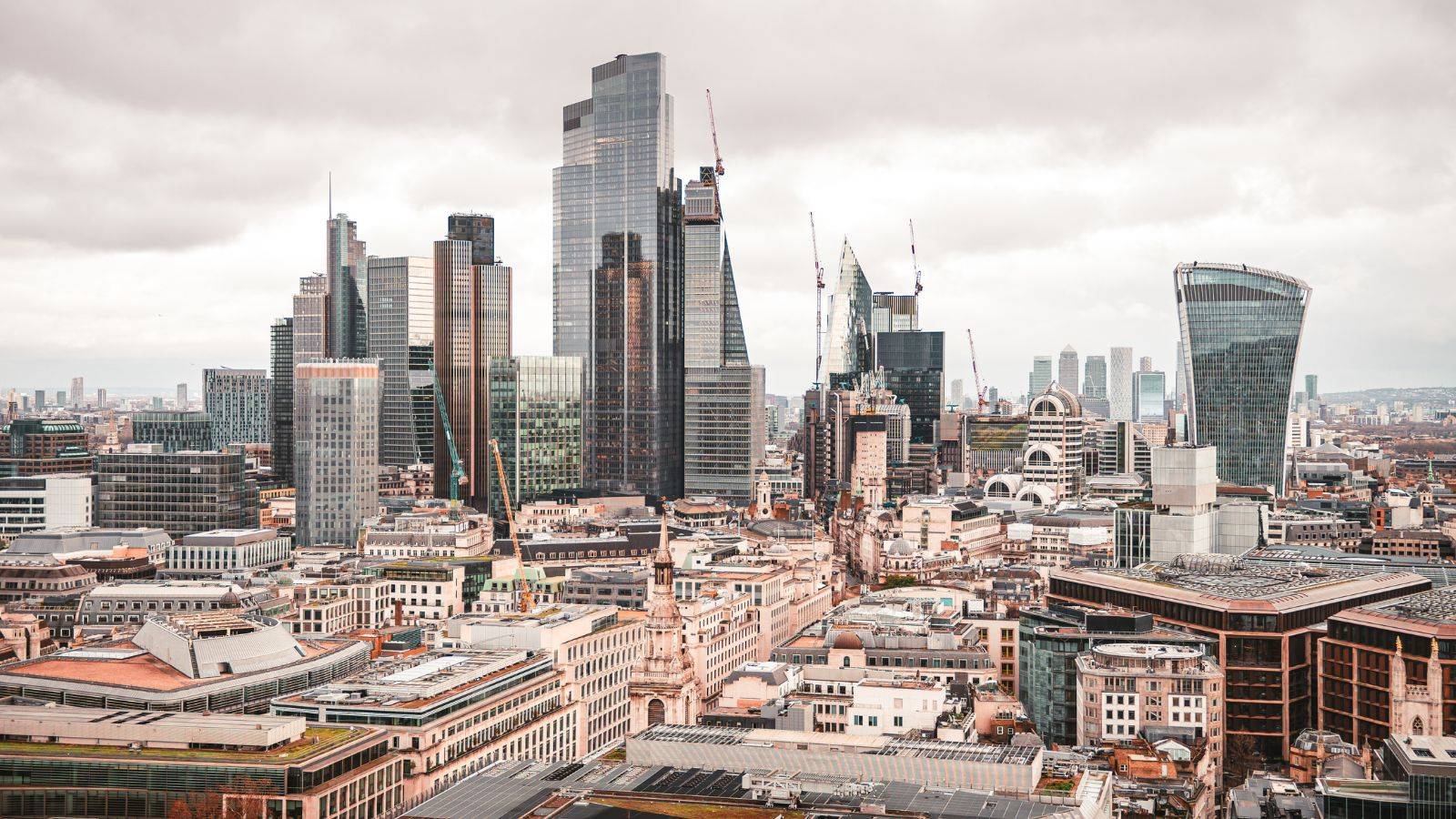 Aerial view of City of London financial district with modern skyscrapers and commercial office buildings representing purchasing commercial property UK 2025 market