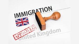 UK immigration approval stamp with Union Jack flag and official documents representing UK spouse visa requirements 2025 success