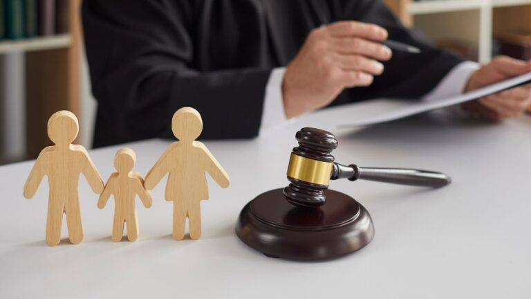 Wooden family figures with judge's gavel representing what is CAFCASS UK 2026 role in court
