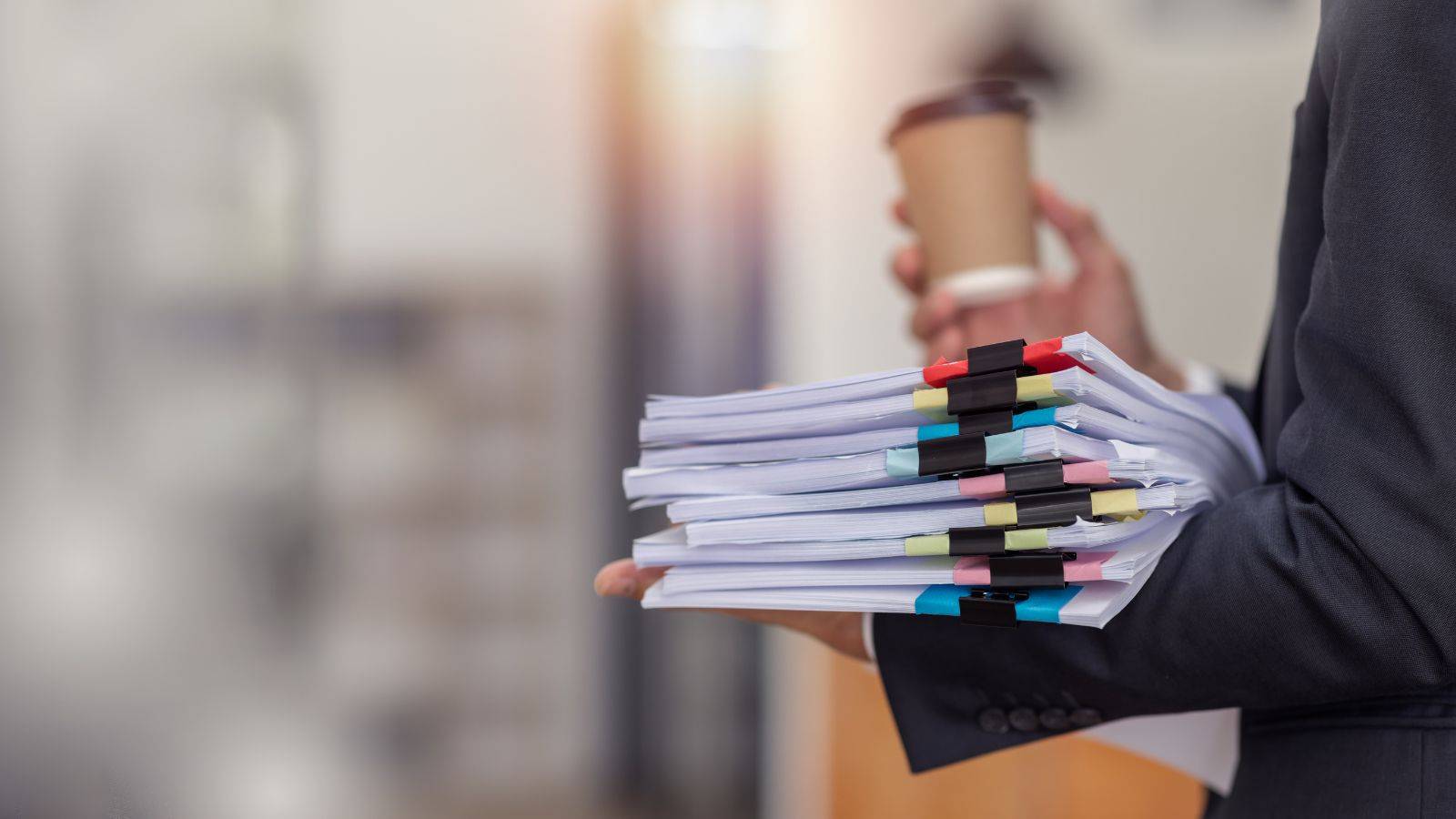 Professional holding organized legal documents representing stateless person UK 2025 complete guide documentation requirements