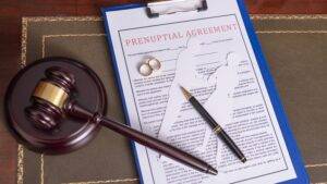 Prenuptial agreement document with judicial gavel and wedding rings representing prenuptial agreements UK 2025 legal framework and enforceability