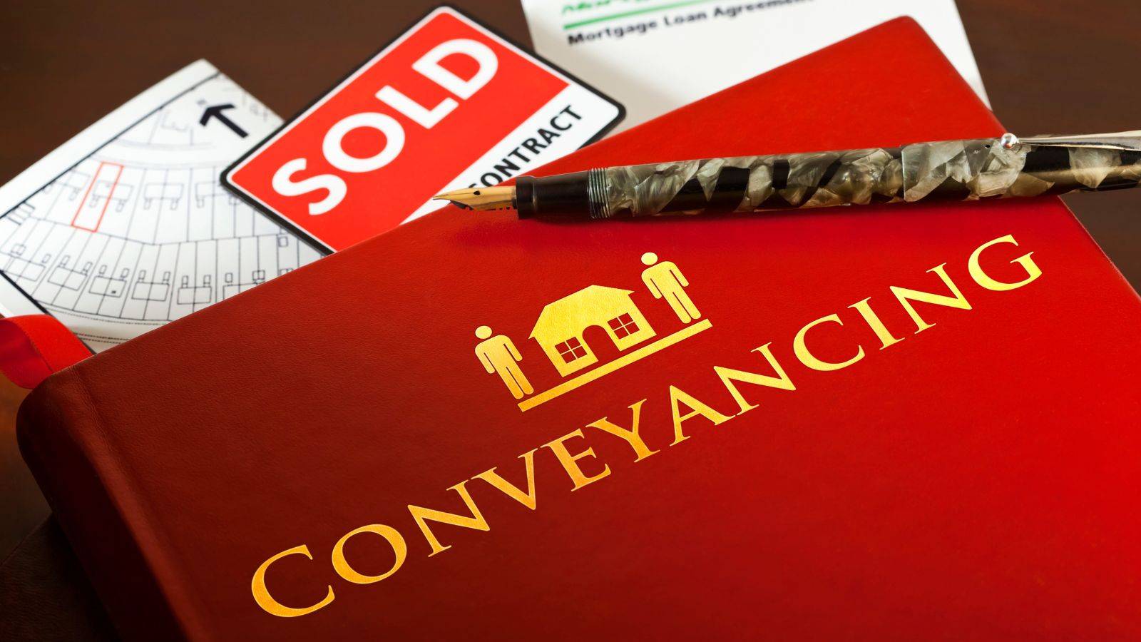 Conveyancing legal documents with SOLD sign and new build blueprints representing new build conveyancing 2025 services