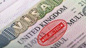 UK visa document with red rejected stamp illustrating UK visit visa refusal reasons 2025 including genuine visitor test failures and common rejection causes