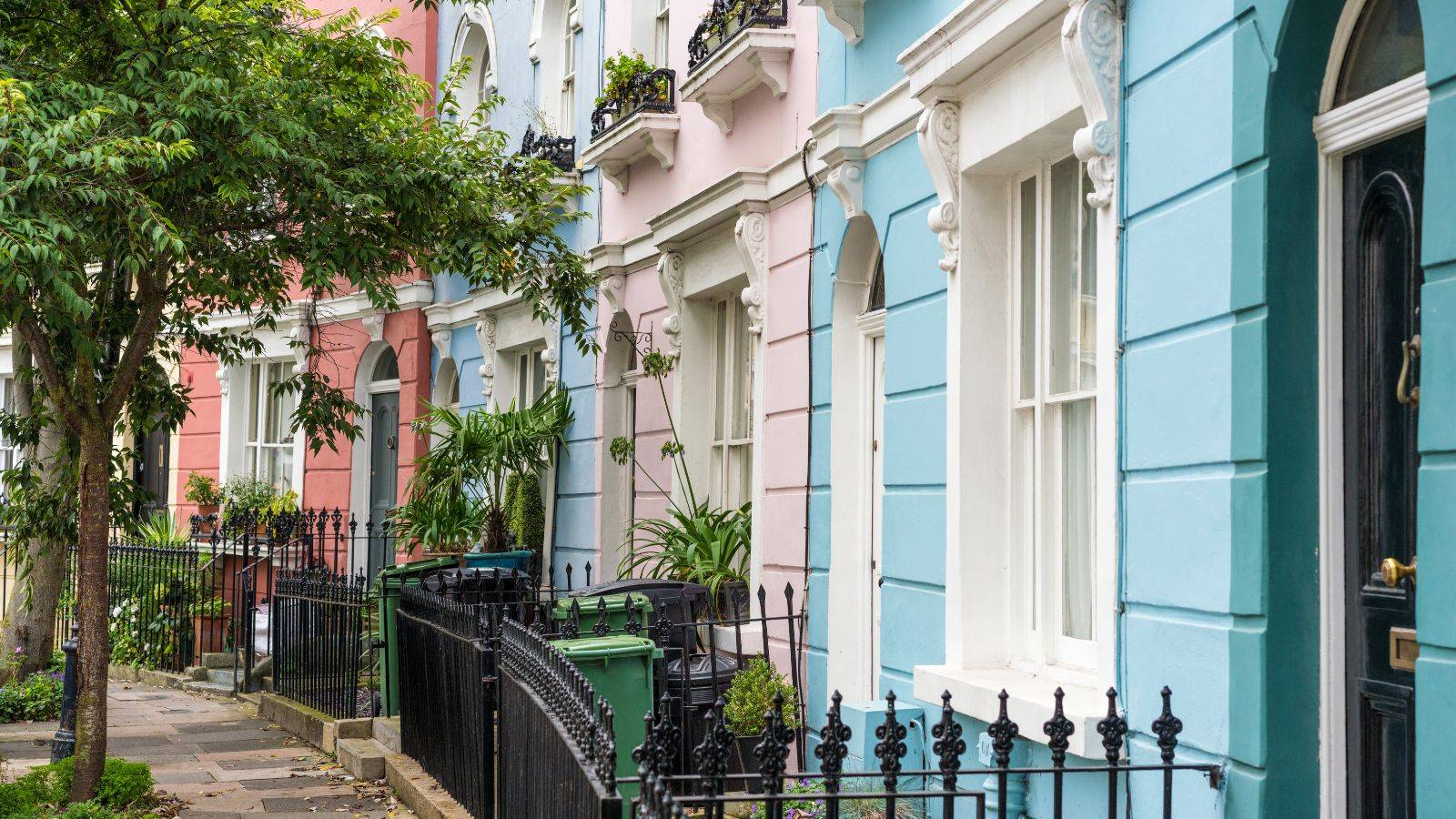Pastel colored terraced houses in Camden North London representing typical UK leasehold properties featured in selling leasehold property UK 2025 legal guide