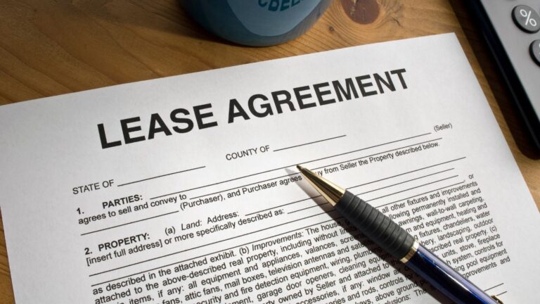 Lease Agreement Document With Calculator And Pen Representing Grant Of New Lease Uk 2025 Premium Calculations And Landlord Legal Requirements