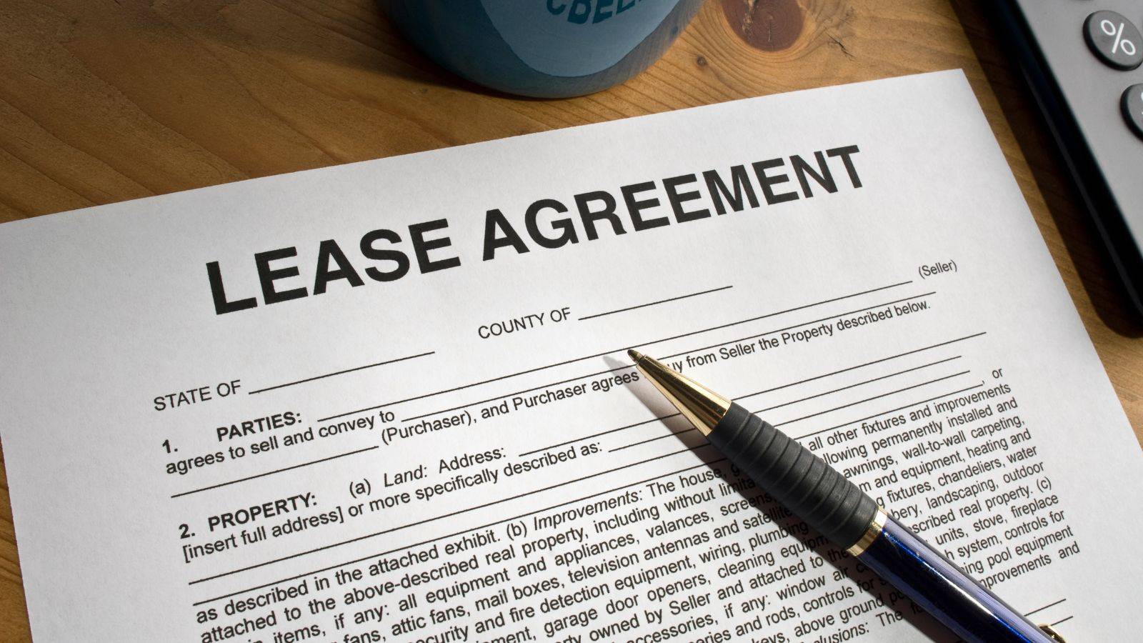 Lease agreement document with calculator and pen representing grant of new lease UK 2025 premium calculations and landlord legal requirements