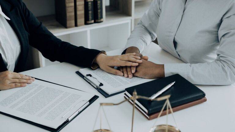 Professional legal consultation meeting with scales of justice representing legal aid domestic violence cases UK 2025 assessment and support