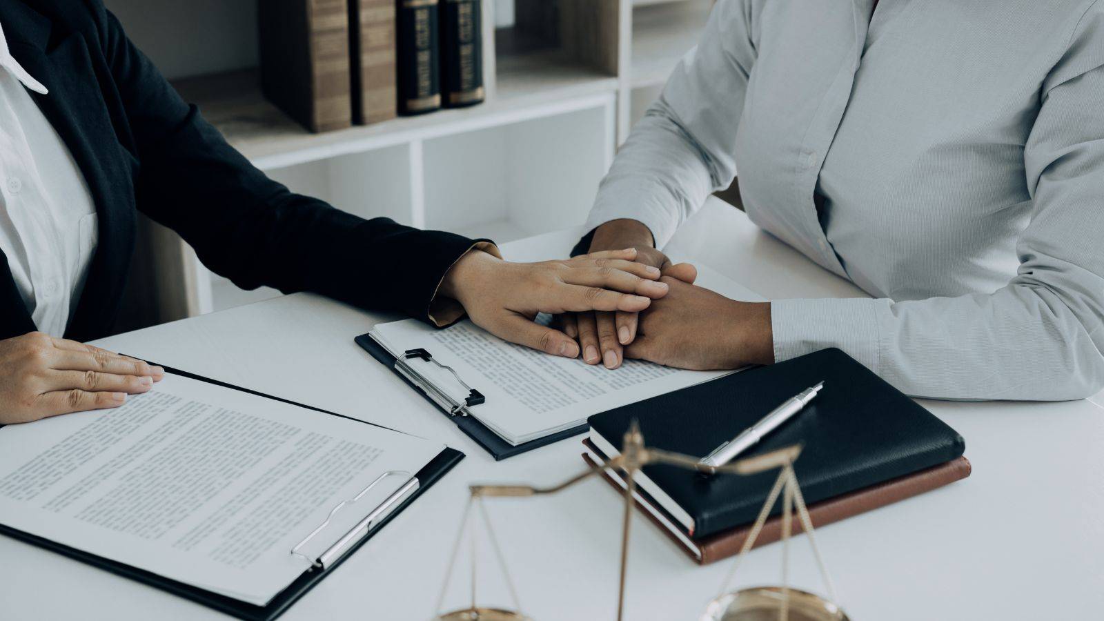 Professional legal consultation meeting with scales of justice representing legal aid domestic violence cases UK 2025 assessment and support