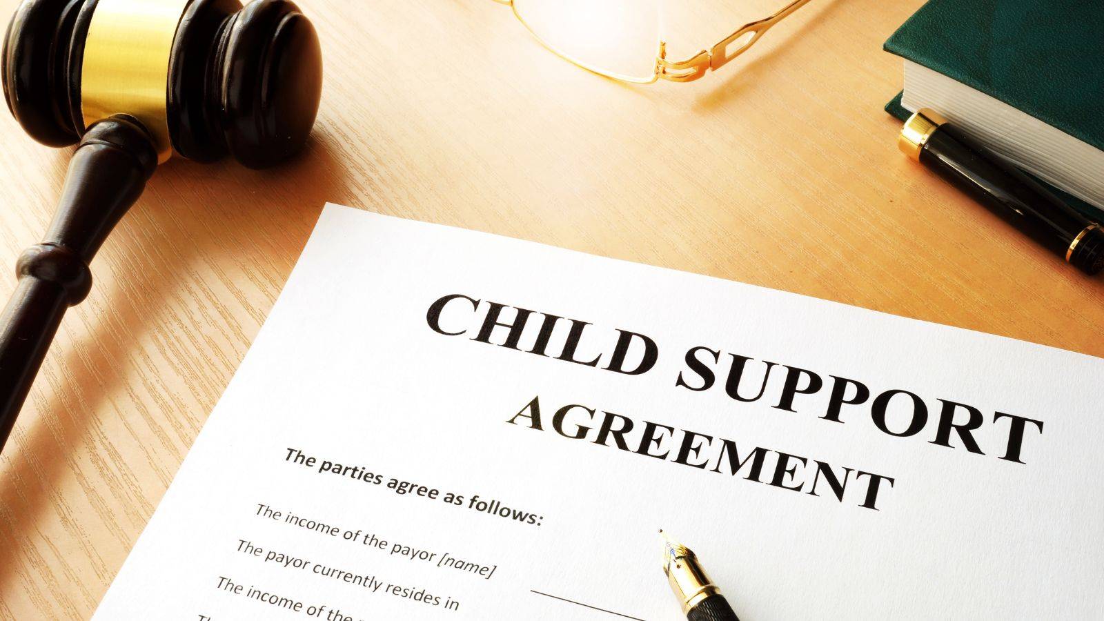 Legal gavel with child support agreement documents representing what is child maintenance UK 2025 legal requirements