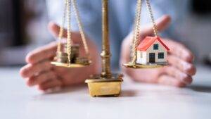 Connaught Law Blog 2 Scales Of Justice With Protected House Model Representing Ring-Fencing Assets Divorce Uk 2025 Legal Protection Strategies