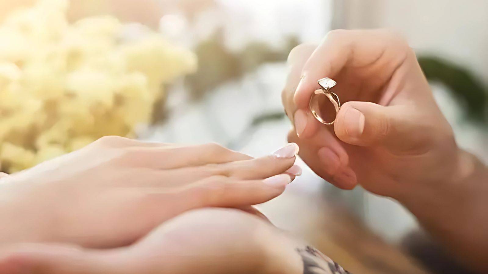 Couple placing engagement ring symbolizing relationship milestone requiring uk fiance visa 2025 application for international partnerships