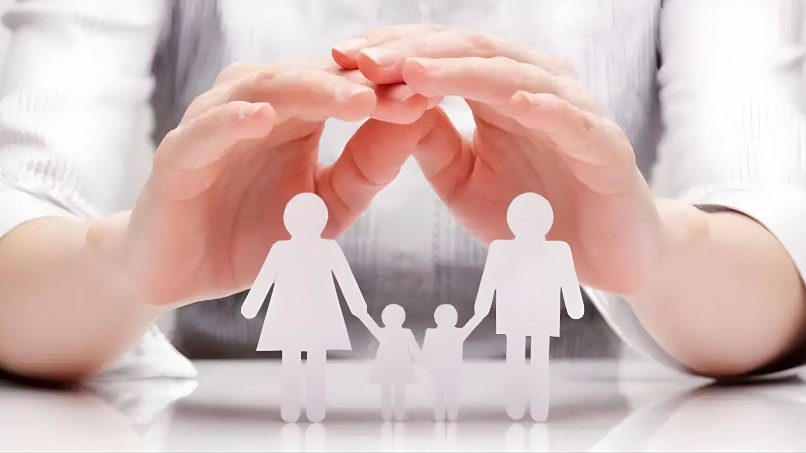 Professional hands creating protective shelter over white paper family cutout representing advantages and disadvantages of family mediation UK 2025 preserving family relationships